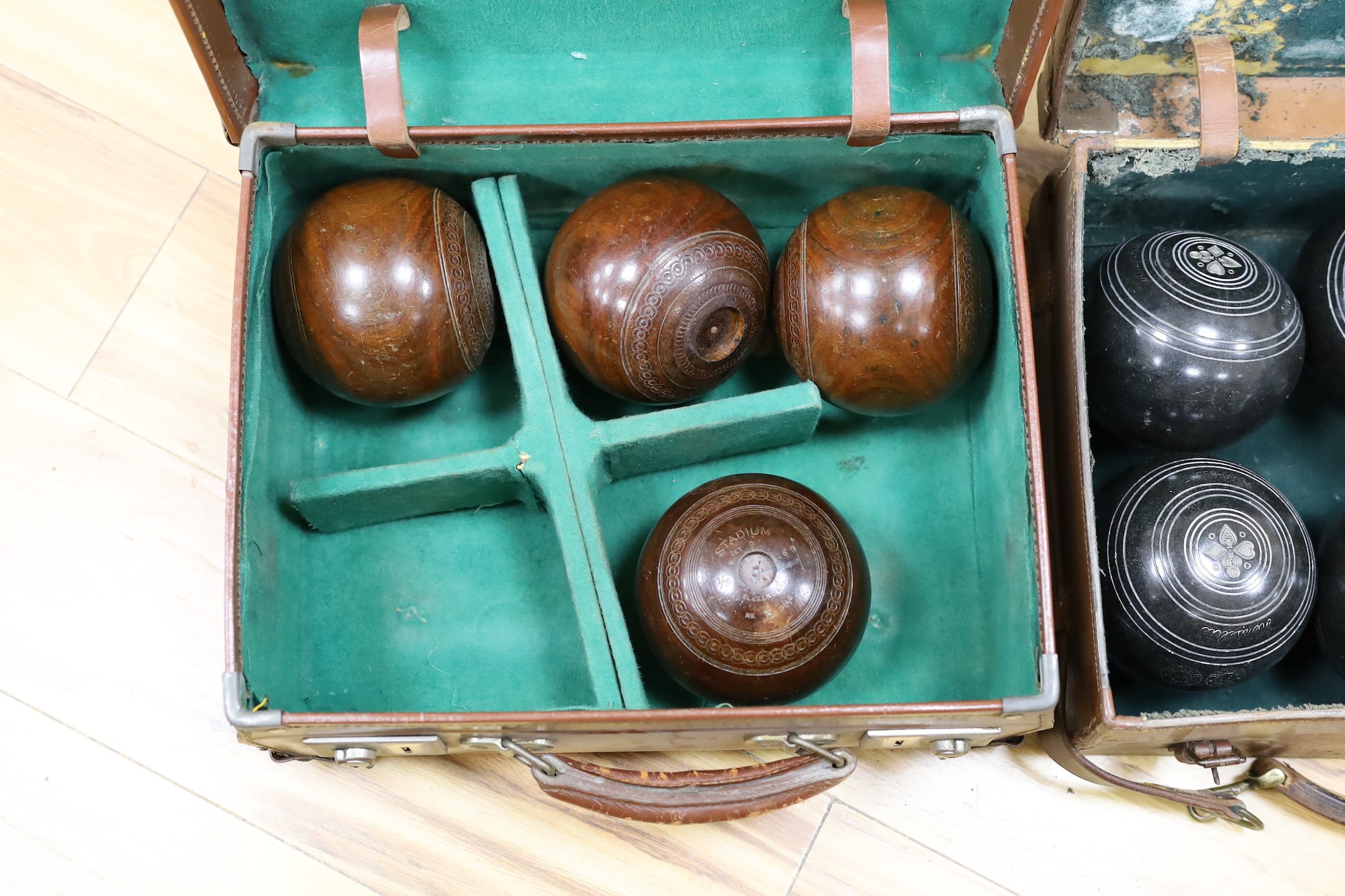 A set of four Slazengers bowls balls and another set of four Douglas Kenn ltd. ‘Henselite’ bowls balls, both in leather cases